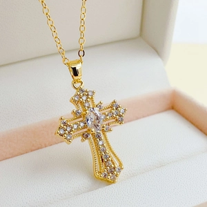 Luxurious gold cross necklace with inlaid zircon crystals in a soft jewelry box