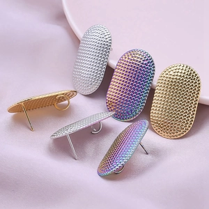 Detailed view of textured oval earring bases in gold, silver and rainbow stainless steel