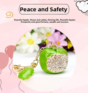 Detail of green apple keychain featuring sparkling rhinestones and gold-tone metal chain