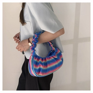 Close-up of vibrant rainbow gradient crescent bag with trendy pleated cloud texture