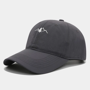 Detail of dark grey quick-dry baseball cap with white mountain embroidery on front