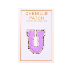 Detailed view of purple chenille letter U patch with gold glitter edge and peel adhesive