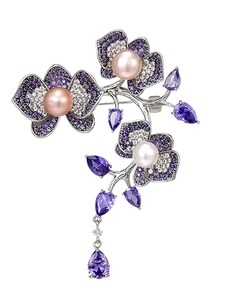 Detail of luxury flower brooch with purple stones and pink pearls in silver finish