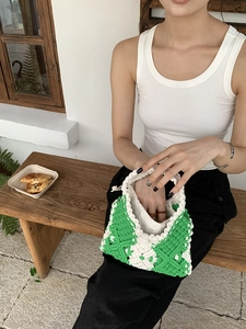 Detail of green and white macrame hand-woven bag with a canvas drawstring lining