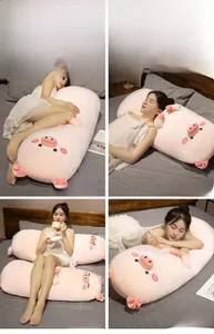 Pink long pig plush pillow used as a backrest, bolster, and leg support in bed