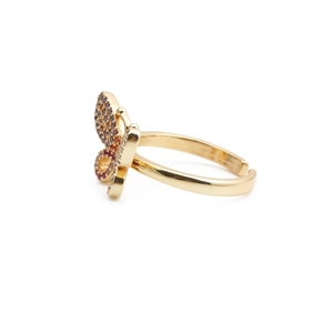 Detailed side view of golden butterfly ring with vibrant purple and orange zircon stones