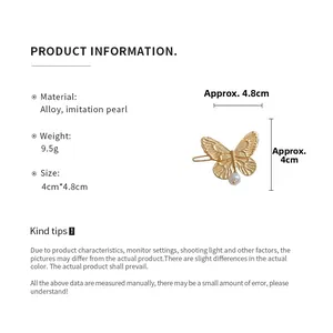 Detail view of butterfly hair clip with dimensions 4.8cm by 4cm and faux pearl accent