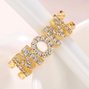 Macro shot of gold-plated MOM letter ring with micro-pave cubic zirconia stones