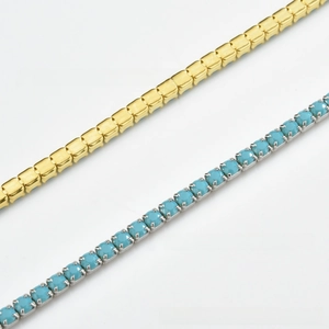 Detail of silver S925 tennis bracelet featuring turquoise stones and a gold claw chain