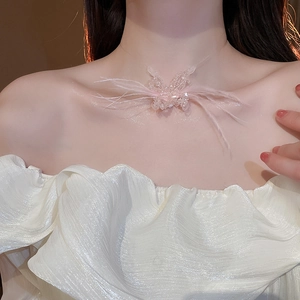 Close-up of a pink goose feather butterfly necklace on a beaded transparent fishline