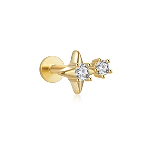 Close-up of a gold star stud earring with clear crystals and a flat-back post design