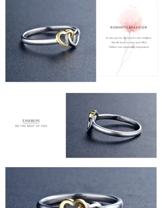 Macro detail of S925 sterling silver ring showing interlocking silver and gold hearts