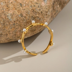 French vintage gold pearl open ring with elegant minimalist design on natural stone base