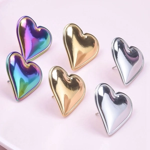 Detailed view of heart-shaped stainless steel earrings in silver, gold, and rainbow colors