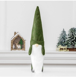 Detail view of festive green Christmas gnome wine bottle cover with soft white beard