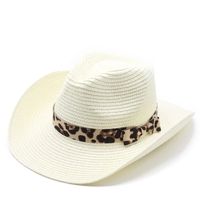 Close-up of ivory cowboy straw hat featuring a leopard print band and bow detail