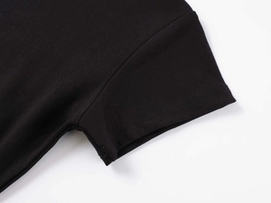Close-up of black modal t-shirt showing high-quality double-needle stitching on the sleeve