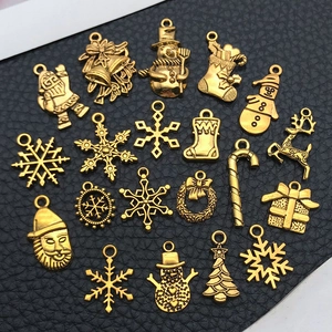 Detailed collection of antique gold Christmas charms on a black textured background