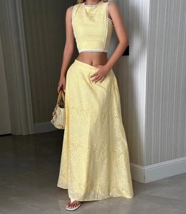 Détail du haut court sans manches jaune pâle et de la jupe à broderie florale