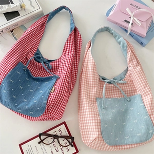 Detail of checkered canvas bags with denim pocket and bow embroidery for women