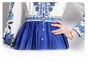 Detailed view of high-waist design with blue floral prints and pleated skirt texture