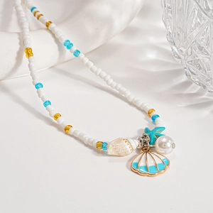 Detailed close-up of beaded necklace with seashell, starfish, and pearl charms for summer