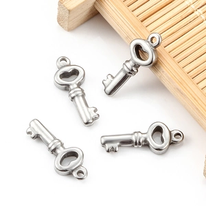 Macro shot of four polished silver stainless steel key charms for DIY jewelry making