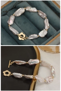 Detail of baroque pearl bracelet with golden flower OT buckle on blue velvet and tray