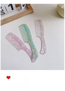 Set of three acetate hair combs in pink, green, and lilac with elegant marble texture