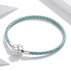 Light blue braided leather bracelet with sterling silver floral clover clasp closure