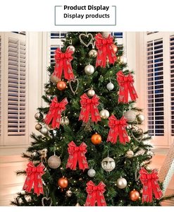 Double-layered red Christmas bow with silver tree patterns hanging on a Christmas tree