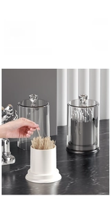 Detail of minimalist cotton swab and toothpick holder with crystal lid and marble base