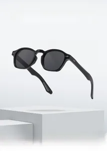 Detail view of black square frame sunglasses with silver rivets on a white pedestal