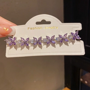 Detailed shot of purple butterfly bracelet with crystals on a jewelry display card