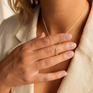 Detailed close-up of a delicate stainless steel Virgo constellation pendant on a fine chain