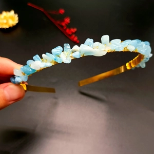 Detail of handcrafted gold crown headband featuring natural blue crystal gravel stones