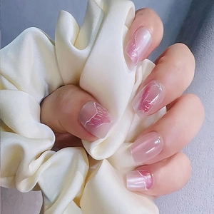 Elegant cat-eye press-on nails with pink gradient and white silk hair tie accessory