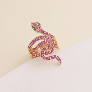 Elegant snake-shaped copper ring featuring pavé pink zircons and green gemstone eyes
