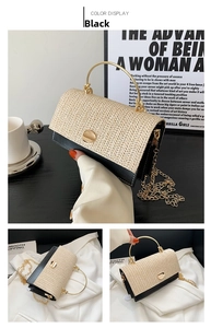 Detail of woven straw handbag featuring gold ring handle and black leather trim