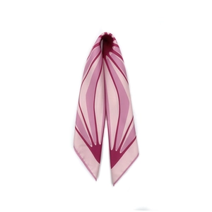 Macro detail of silk scarf showing pink and purple geometric petal patterns and texture