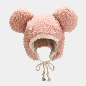 Macro view of pink faux shearling baby bear hat showing warm fleece lining and cotton ties