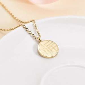 Gold stainless steel necklace with round pendant featuring a Chinese Fu character