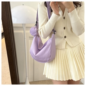 Detail of purple nylon crescent bag with wide strap and matching round coin purse