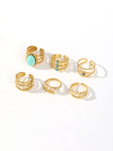 Detailed collection of golden stainless steel rings featuring oval turquoise and pearls