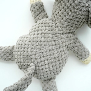 Detail showing grey textured corduroy plush fabric on a durable pet squeaky toy