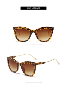 Close-up of leopard print frames with brown gradient lenses and gold metal temples