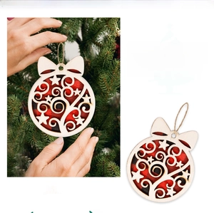Detail of round wooden Christmas ornament with buffalo plaid and cutout star patterns