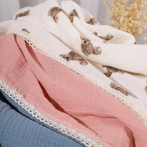 Soft double-layer cotton baby gauze blanket featuring cute bear prints and elegant lace trim.