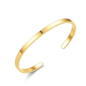 Detailed close-up of a sleek gold-finished stainless steel C-shaped open cuff bracelet