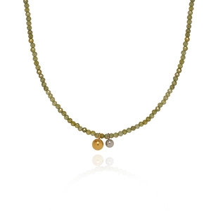 Olive green beaded necklace with gold and silver tone spherical pendants on white backdrop